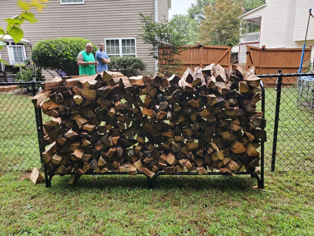 Major Firewood Delivery team stacking cord at customer home